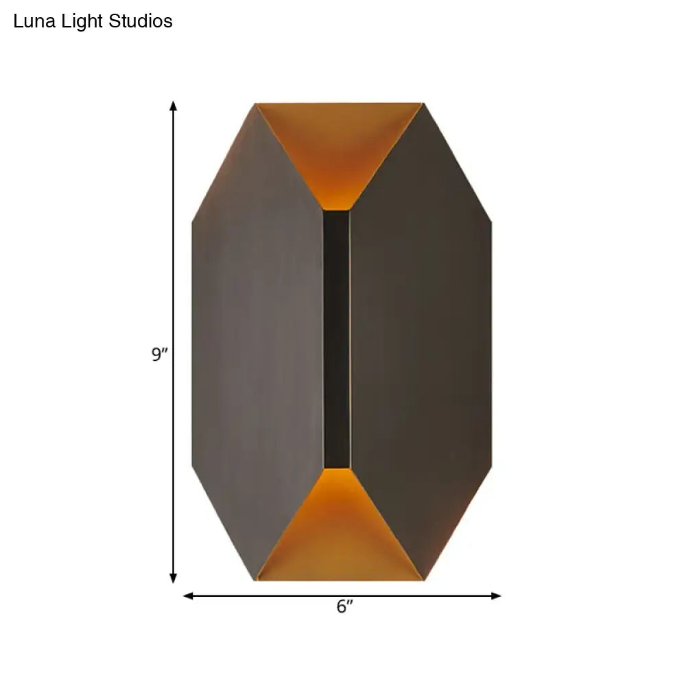 A sleek modern black and gold geometric wall lamp with matte dark bronze exterior and warm amber LED lighting