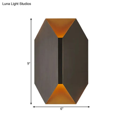 A sleek modern black and gold geometric wall lamp with matte dark bronze exterior and warm amber LED lighting