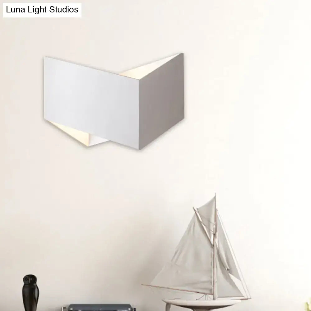 Modern black and gold metal body wall lamp with a white geometric light type and sleek angular design for stairway lighting
