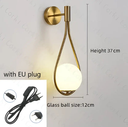 Gold-toned wall lamp with sleek teardrop metal frame and frosted glass globe decorbites glass ball led bedroom sconce