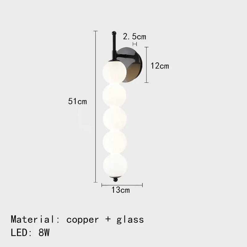 Modern black and gold glass bedside led wall lamp with five frosted glass spheres on a sleek copper bracket for decorbites wall lamp