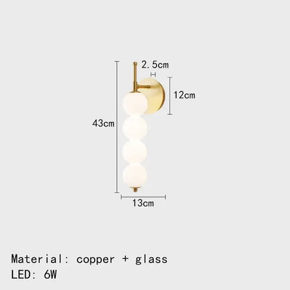 Modern black and gold glass bedside led wall lamp with brass-finished copper base and four frosted glass spheres decorbites glass bedside