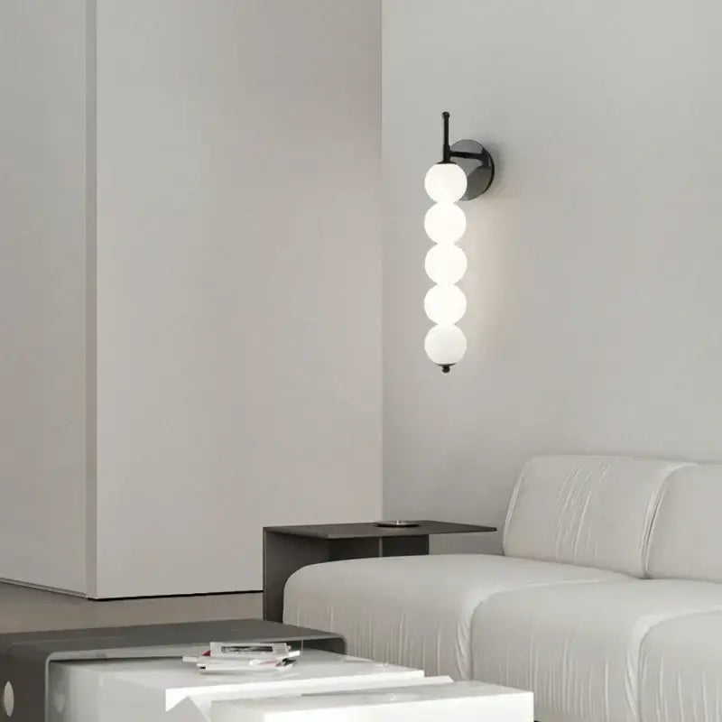 Modern black and gold glass bedside led wall lamp with five white spherical glass shades for bedroom decorbites wall lamp