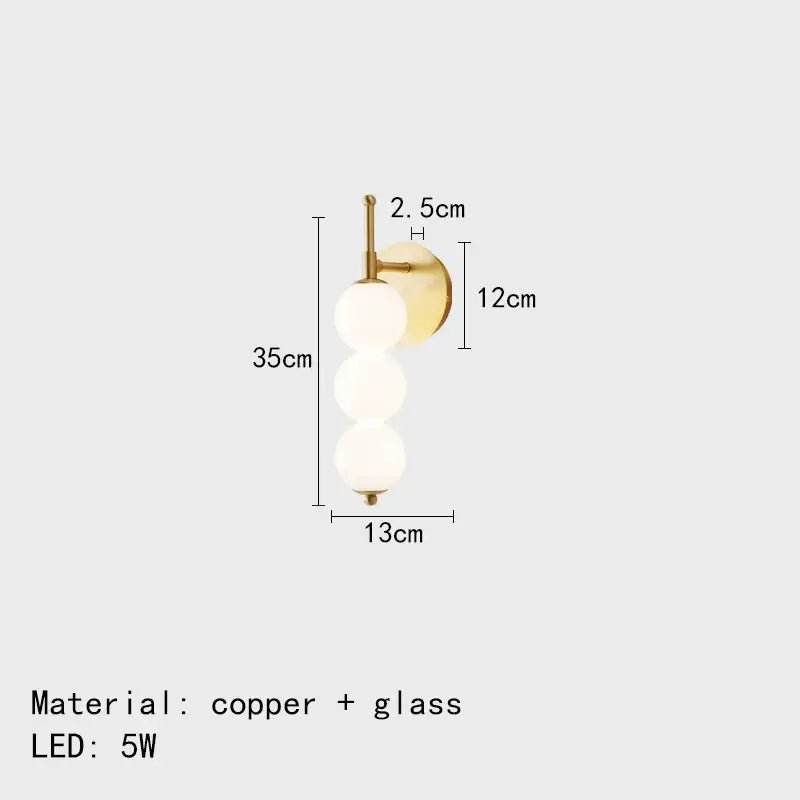Modern black and gold wall lamp with gold-toned copper base and three frosted glass spheres for decorbites glass bedside led use
