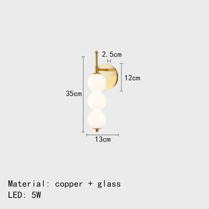 Modern black and gold wall lamp with gold-toned copper base and three frosted glass spheres for decorbites glass bedside led use