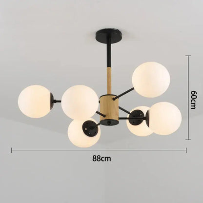 Modern pendant light with six frosted glass globes black metal arms and wooden cylinder decorbites black gold glass design