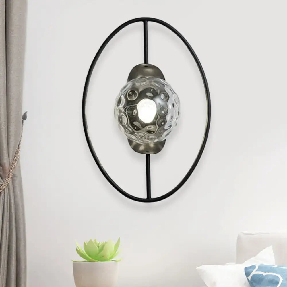Modern black wall lamp with oval metal frame and clear textured glass globe for bedroom fixture type lighting