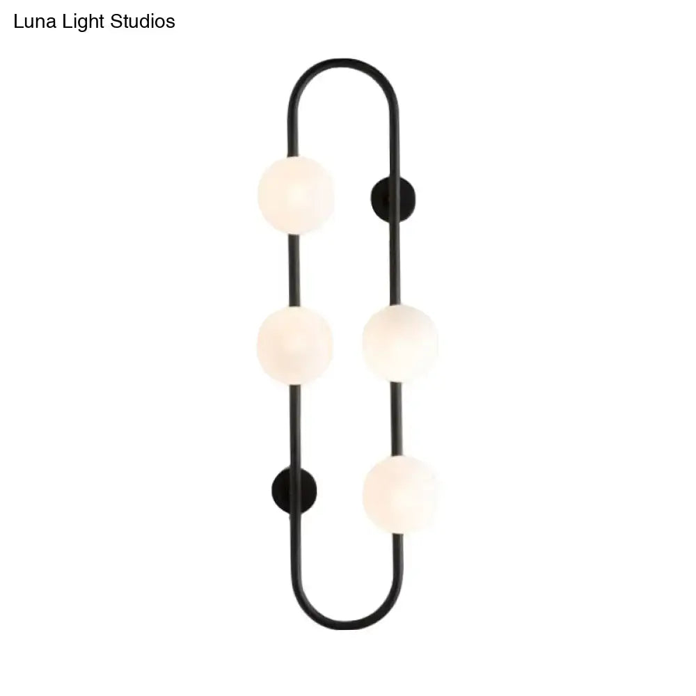 Modern black metal wall sconce with four white glass frosted globe bulbs in a curved globe wall sconce design