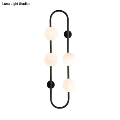 Modern black metal wall sconce with four white glass frosted globe bulbs in a curved globe wall sconce design