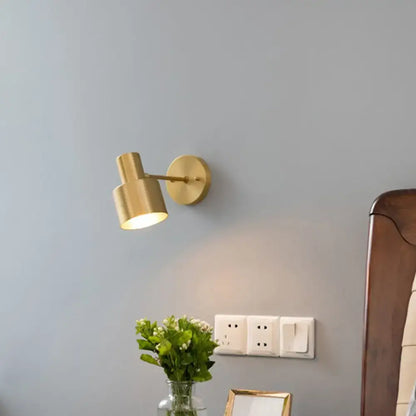 Modern black and gold grenade shaped wall lamp with gold-toned cylindrical reading light and adjustable arm for bedroom use