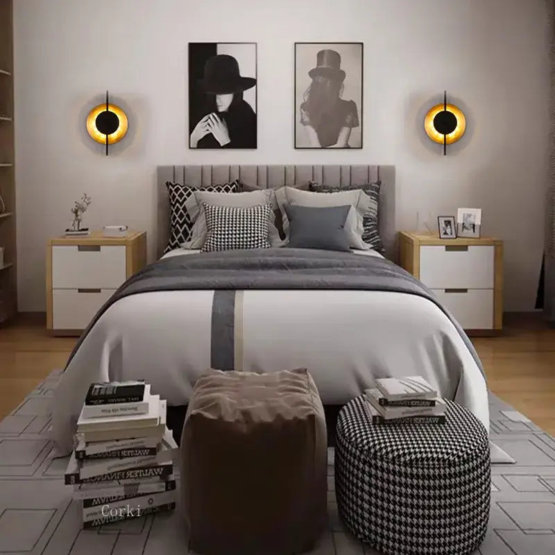 Modern black and gold iron art led wall lamp with gray tufted headboard featuring vertical stitching and soft upholstery