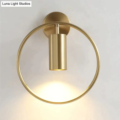 Brass-finished circular wall sconce with cylindrical light fixture modern black and gold irwin wall lamp for bedroom use