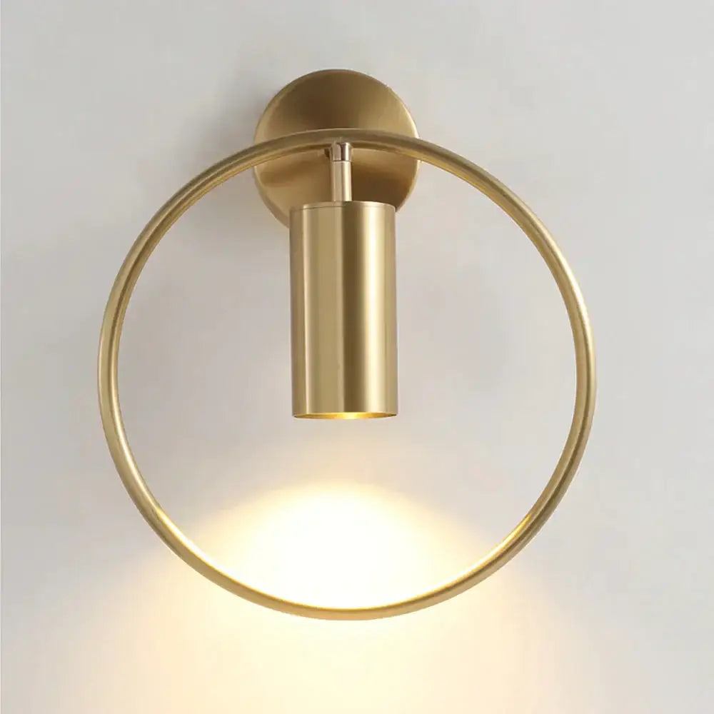 Brass-finished circular irwin wall lamp with cylindrical light fixture modern black and gold bedroom sconce