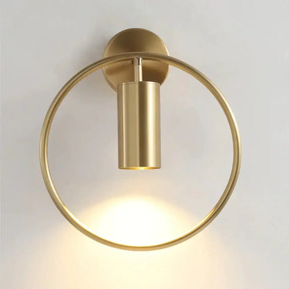 Brass-finished circular irwin wall lamp with cylindrical light fixture modern black and gold bedroom sconce