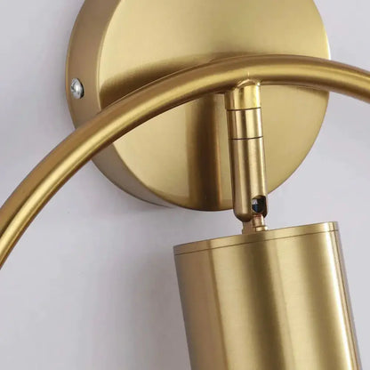Brass-finished irwin wall lamp with curved arm and cylindrical shade modern black and gold bedroom wall sconce