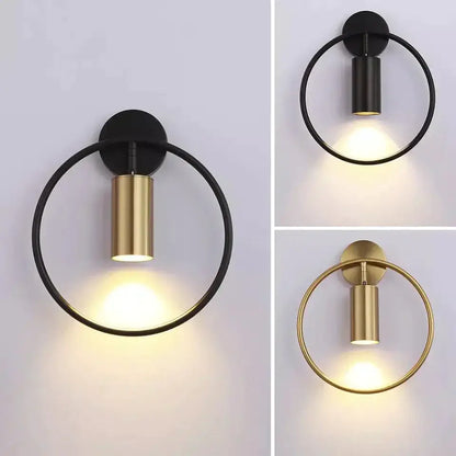 Modern black and gold irwin wall lamp features a circular wall sconce with a sleek cylindrical light fixture