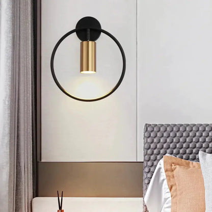 Modern black and gold irwin wall lamp with a sleek cylindrical light fixture for bedroom wall sconce lighting