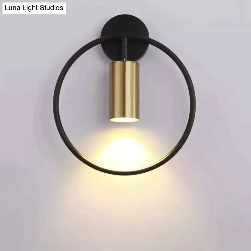 Modern black and gold irwin wall lamp with a sleek minimalist circular design ideal as a bedroom wall lamp