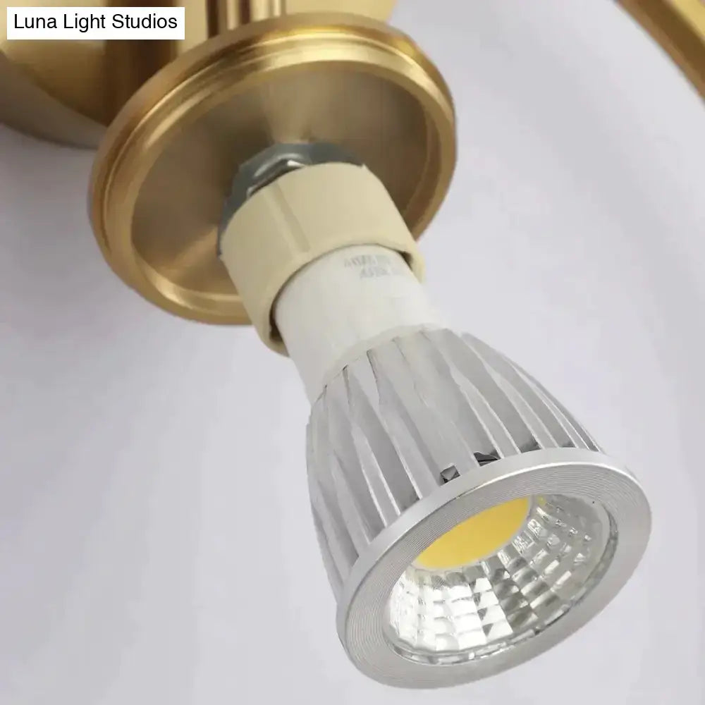 Modern black and gold irwin wall lamp featuring a gold-finished led spotlight with silver heat sink and white base