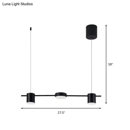 Modern black and gold light fixture with three matte black cylindrical pendant ceiling lights for kitchen island