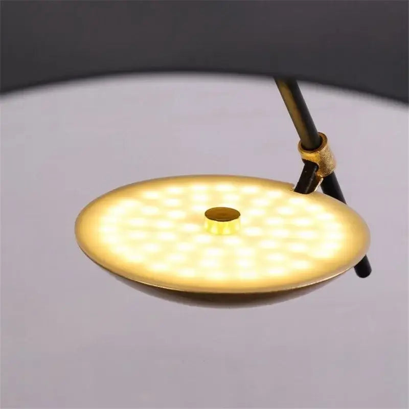 Modern black and gold leaf pendant light with gold texture featuring a gold circular led table lamp for ambient decorbites decor