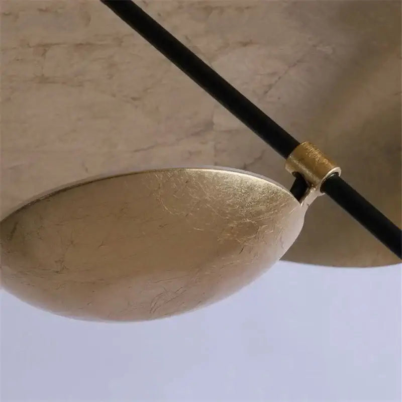 Modern black and gold leaf pendant light with matte gold texture and black cable for living room decorbites gold texture