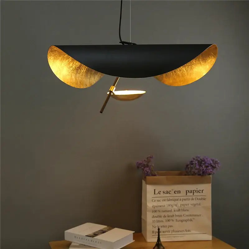 Modern black and gold pendant light with sleek curved metallic panels featuring decorbites gold texture for living room decor