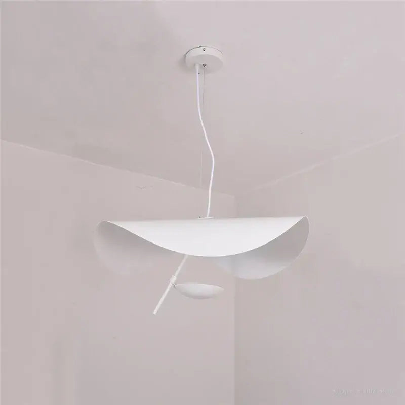 Modern black and gold leaf pendant light with sleek white shell-like shade featuring decorbites gold texture for living room decor