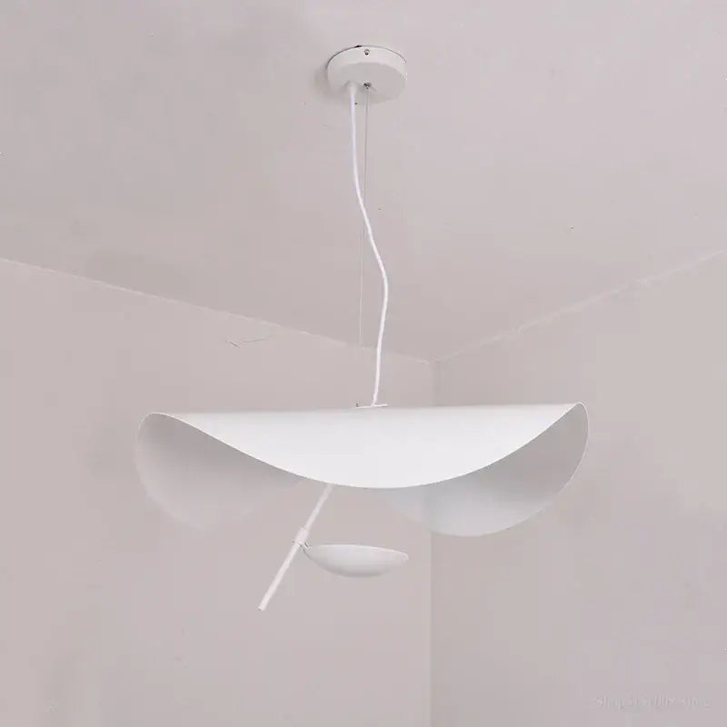 White minimalist pendant light with sleek curved metallic shade and slender cord for modern decorbites gold texture decor