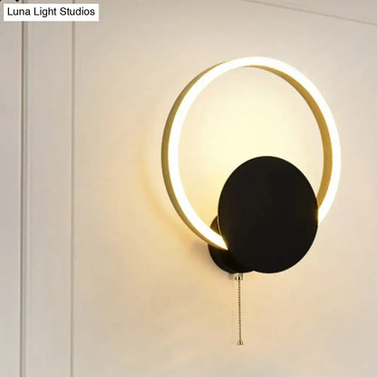 Modern black and gold led bedroom sconce with pull chain featuring a minimalist 12 inch fixture with glowing gold ring