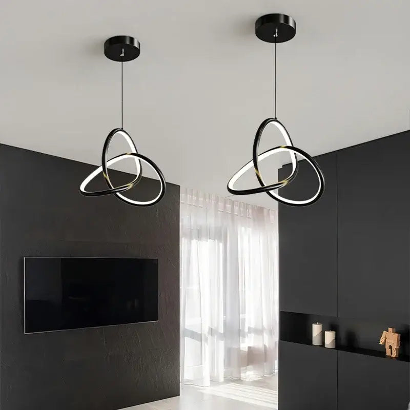 Modern black and gold led pendant light with interlocking black and white rings for dining room lighting