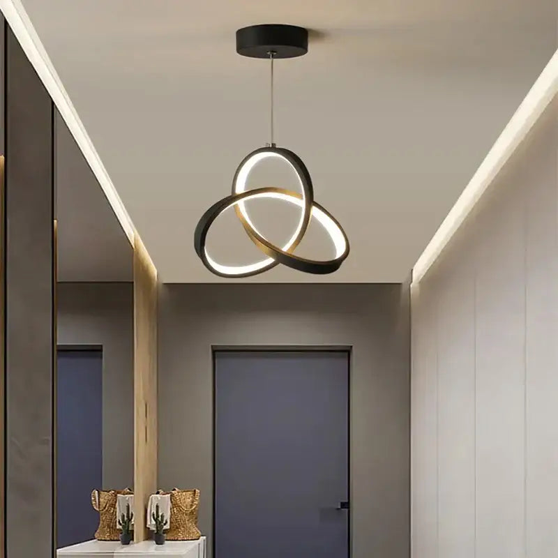 Modern black and gold led pendant light with triple ring illuminated circular design for dining room use