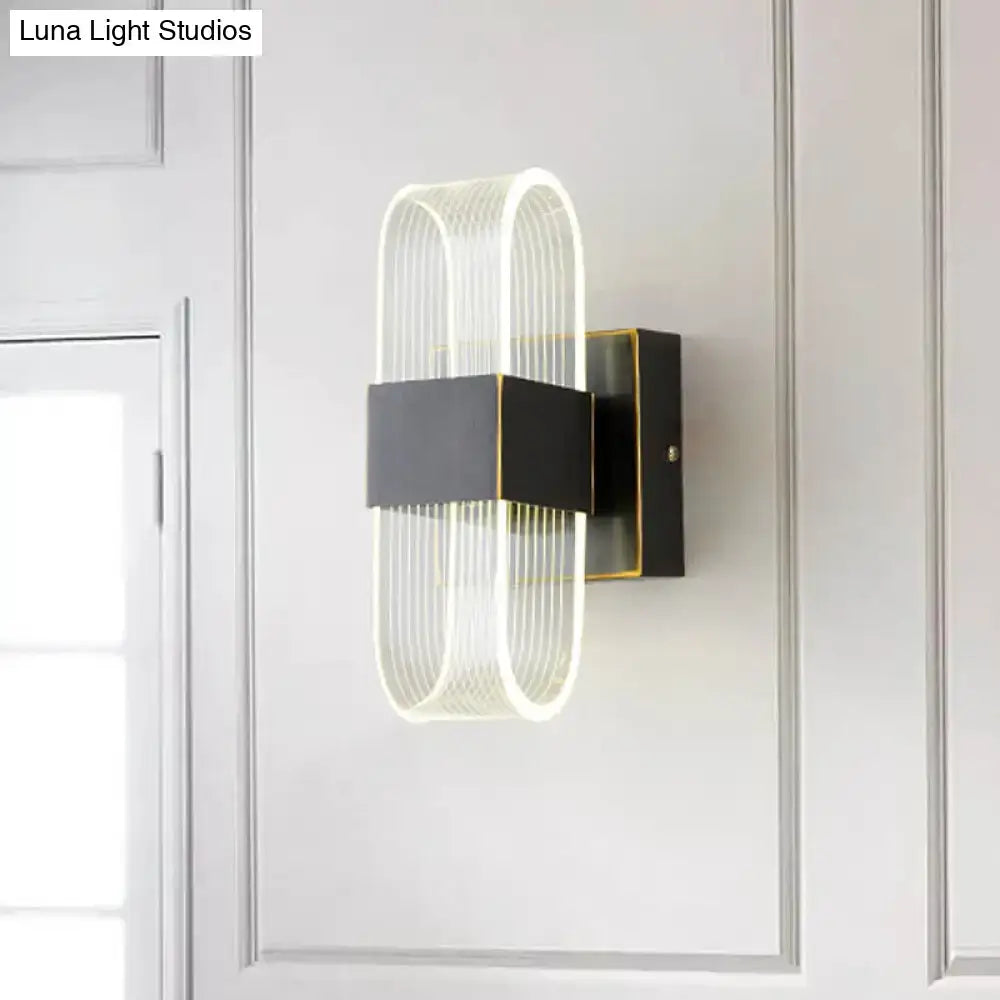 Modern black and gold led sconce light with glowing curved glass design for bedroom oval wall mount installation