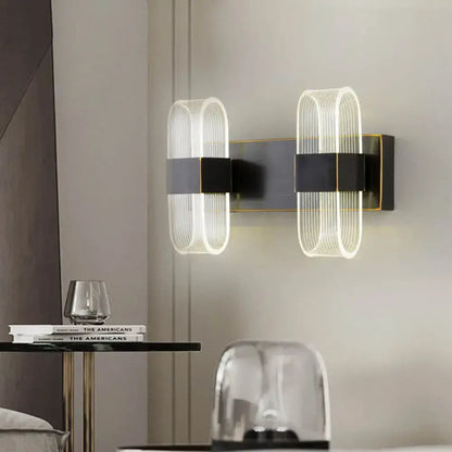 Modern black and gold led sconce light with sleek metal frames and ribbed glass shades for bedroom wall mount
