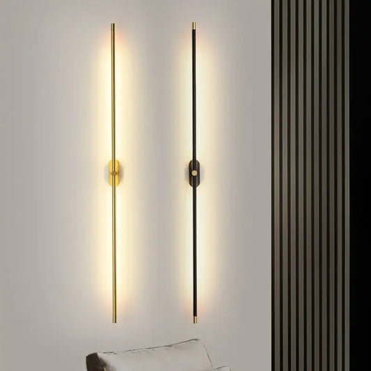 Two modern minimalist wall lamps with black and gold finishes featuring decorbites led strip vertical rods emitting warm light