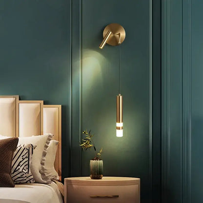 Modern black and gold led wall lamp featuring a gold-toned cylindrical pendant light for adjustable bedroom reading decorbites gold led