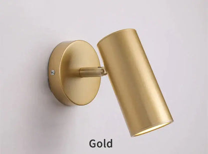 Gold-finished cylindrical led wall lamp with sleek modern design for adjustable bedroom lighting