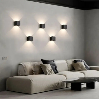 Six sleek black cube-shaped led wall lamps illuminate a minimalist living room modern decorbites led wall lamp design
