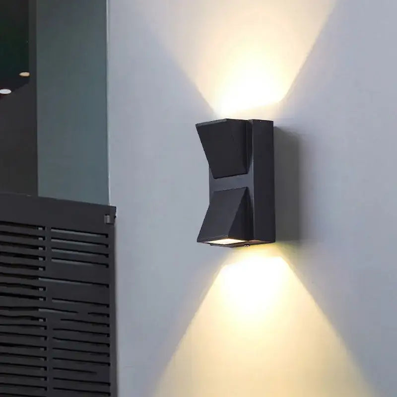 Modern black and gold led wall lamp with sleek angular geometric design casting warm light for living room decorbites led wall lamp