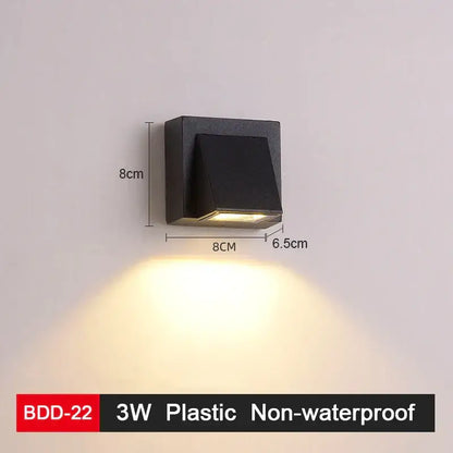 Modern black plastic wall lamp with gold accents and an angled diffuser for sleek living room decorbites led wall lighting