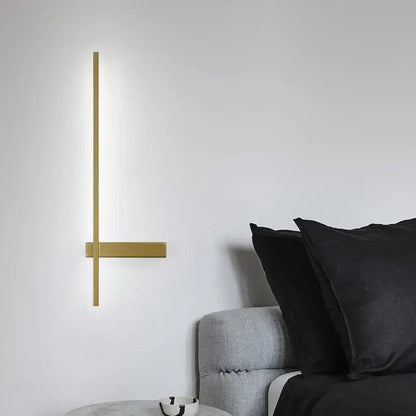 Modern black and gold led wall lamp with a gold-toned minimalist sconce and soft ambient light for living room