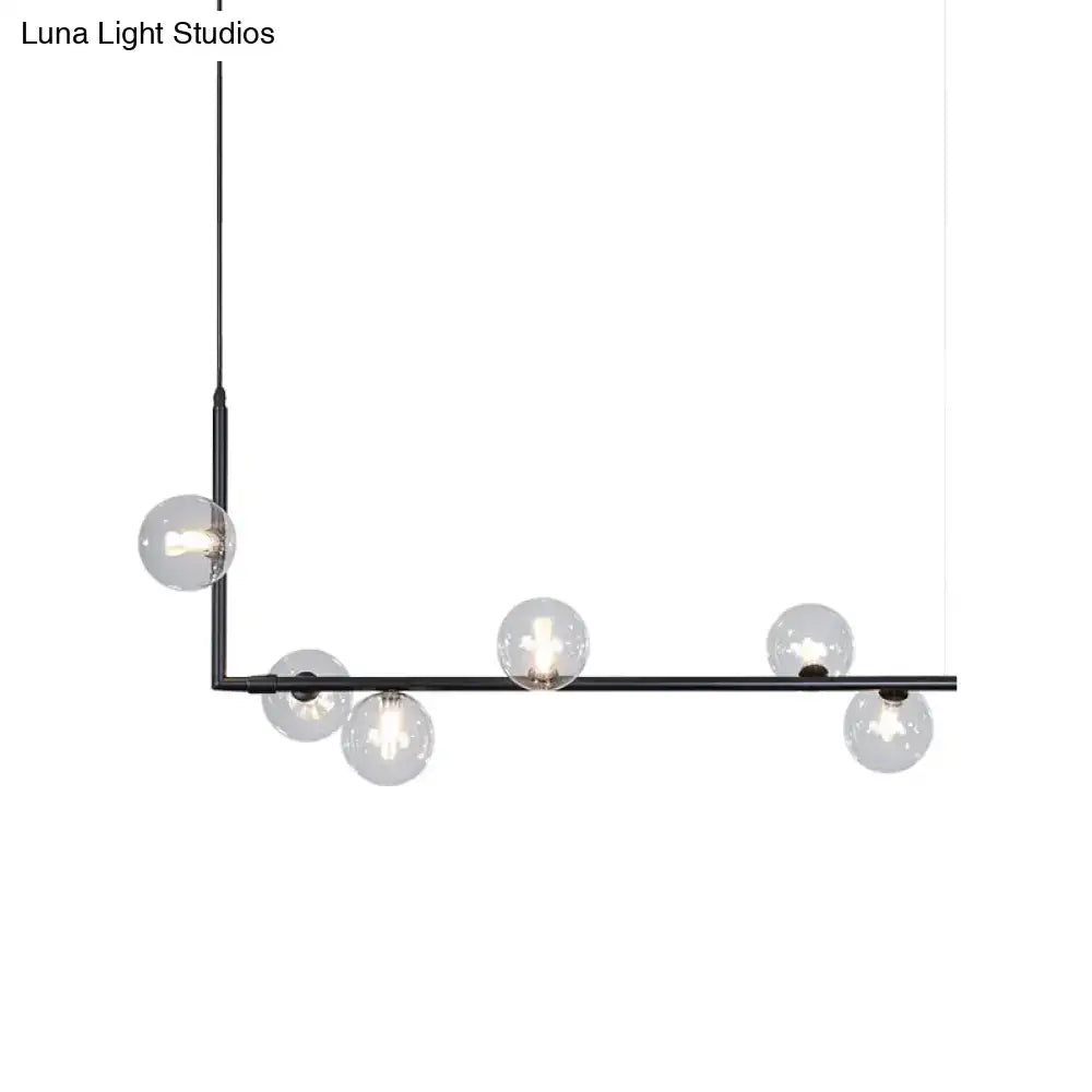 Modern black gold linear chandelier with clear glass globe bulbs ideal for dining room or island lighting