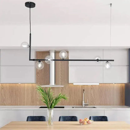 Modern black and gold linear chandelier featuring clear glass globe bulbs for dining room or kitchen island lighting