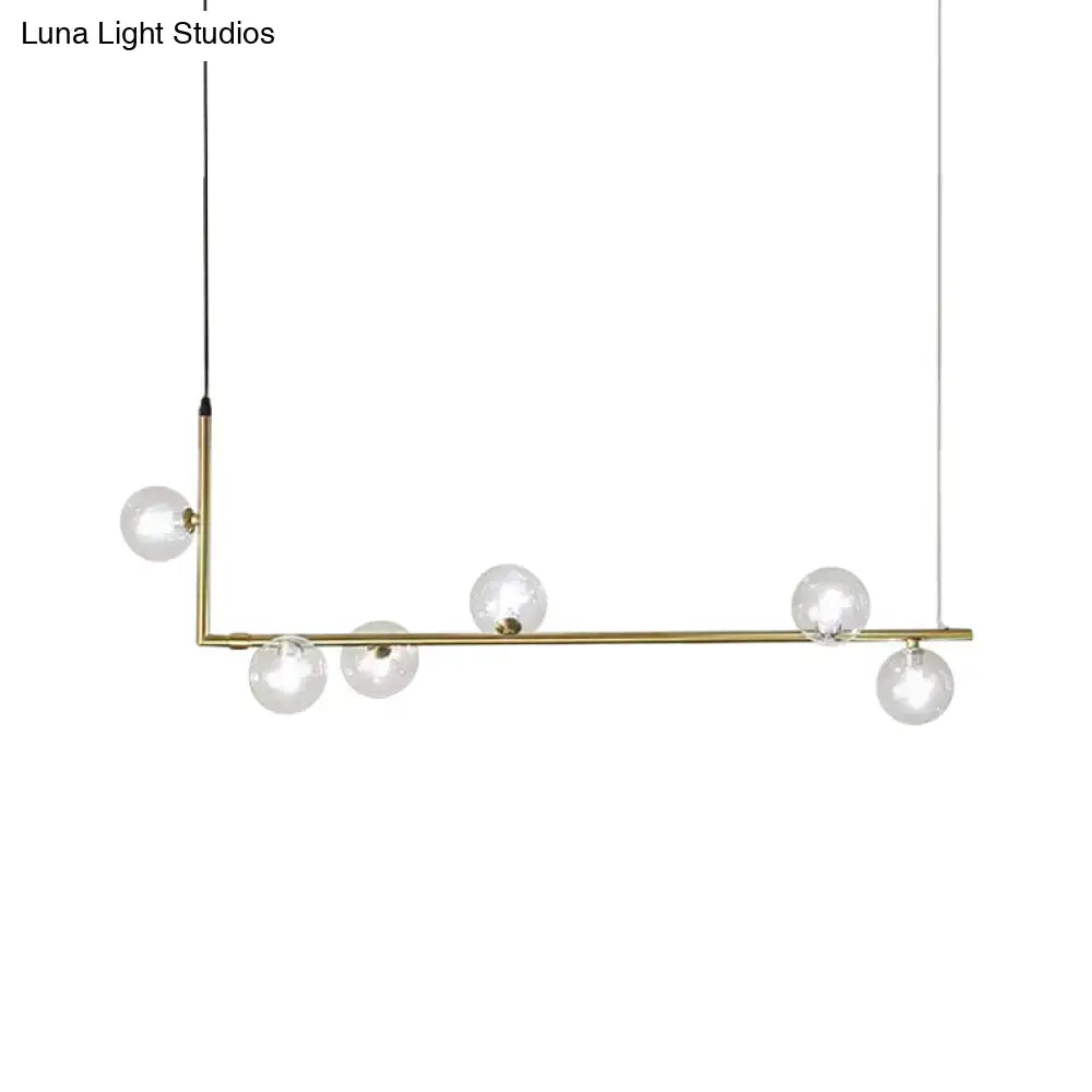 Modern black gold linear chandelier with brass l-shaped frame and five clear glass globe bulbs for dining room island lighting