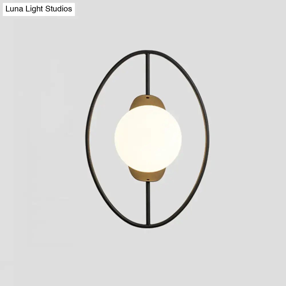 Modern black metal halo ring wall lamp with warm brass accent and white glass globe for bedroom lighting