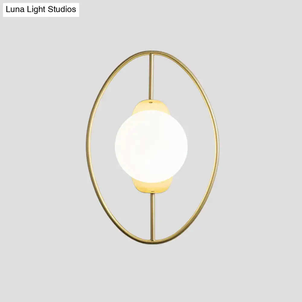 Modern black and gold metal halo ring wall lamp with a gold-toned oval frame and white glass frosted globe wall lamp