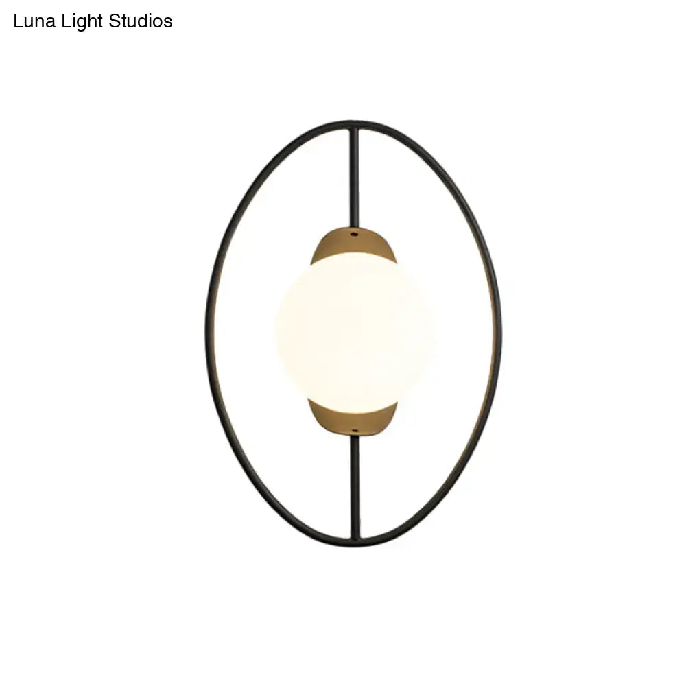 Modern black and gold metal halo ring wall lamp with white glass and warm brass accents for bedroom lighting