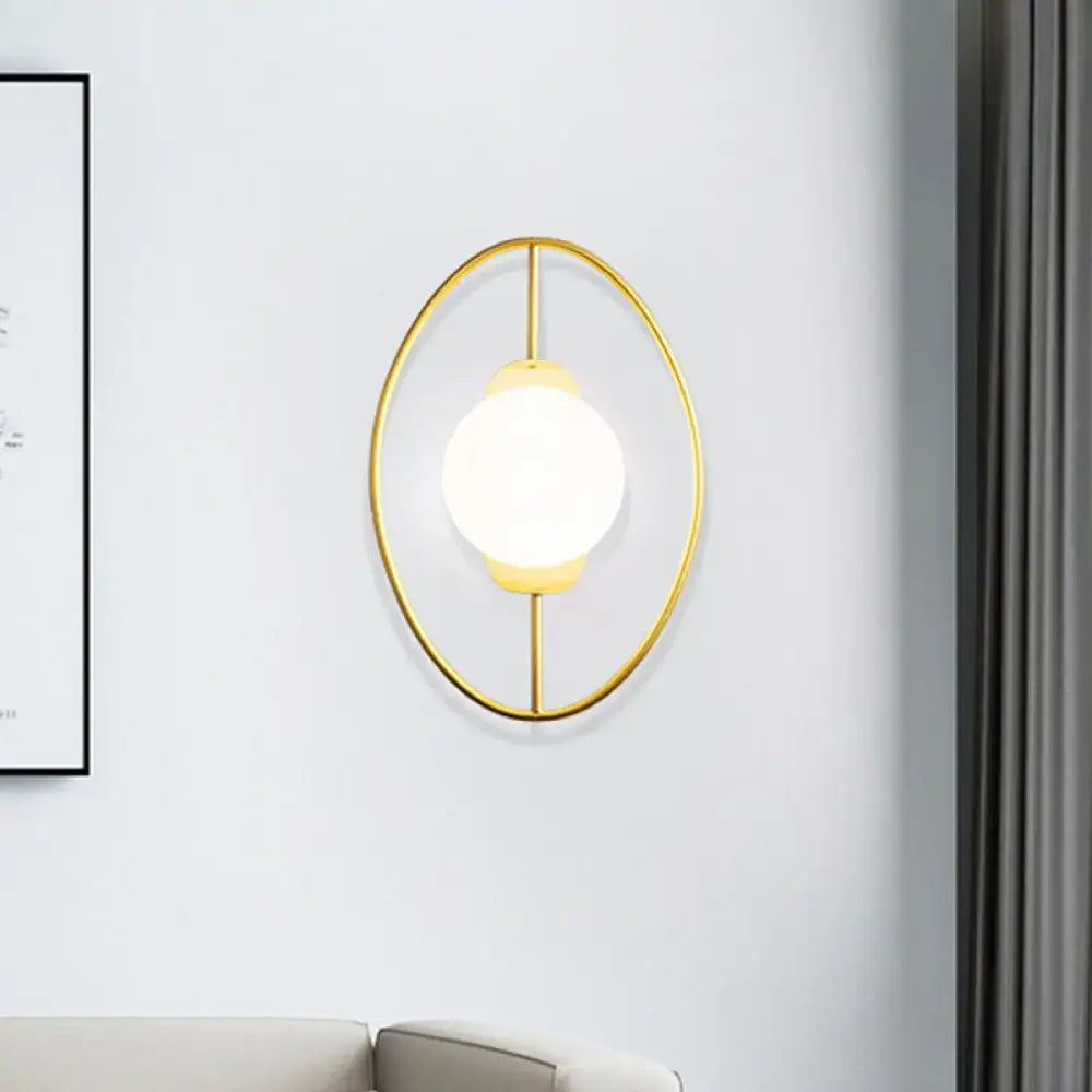 Modern black and gold metal halo ring wall lamp with gold-toned frame and white glass globe for bedroom lighting