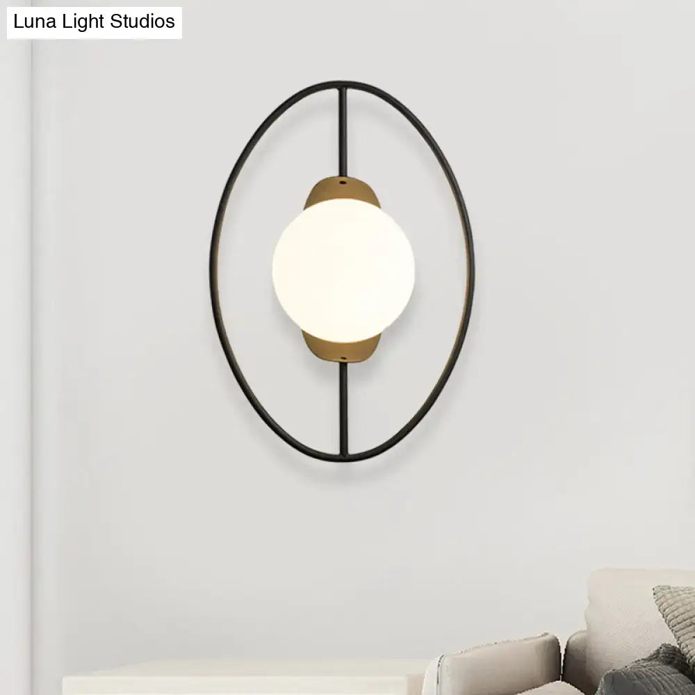 Modern black and brass metal halo ring wall lamp with frosted white glass globe for bedroom lighting