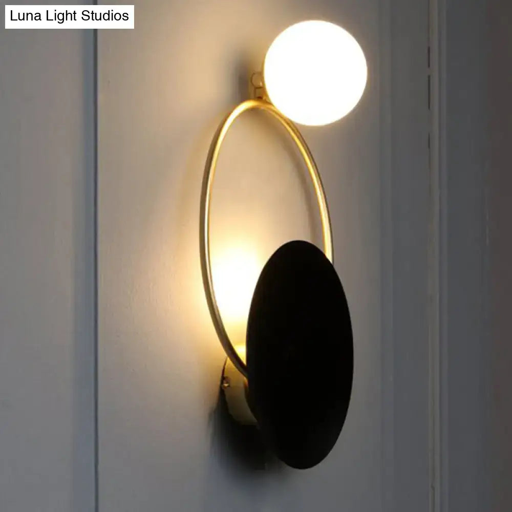 Modern black and gold metal planet wall mount lamp featuring a gold-toned oval sconce with matte black accent